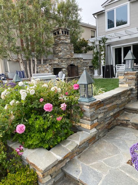 Backyard flagstone patio surrounded by white and pink roses Classic Backyard, Flagstone Steps, Brick Steps, Patio Steps, White And Pink Roses, Flagstone Patio, Patio Fireplace, Vision Board Goals, Pizza Place