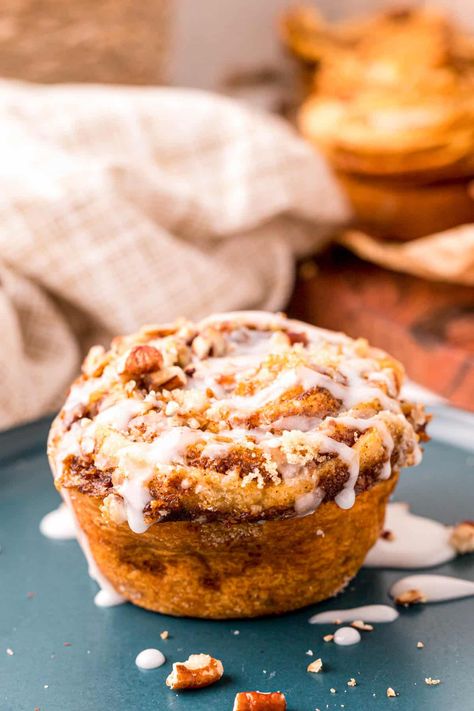 Easy Pumpkin Cinnamon Roll Muffins are overflowing with the glorious flavors of fall yet take less than 20 minutes to bake up to tasty perfection! Topped off with sweet brown sugar, crunchy pecans, and a 2-ingredient glaze! Cinnamon Roll Pumpkin, Cinnamon Roll Muffins, Brown Sugar Glaze, Crunchy Pecans, Pumpkin Muffins, Easy Pumpkin, Cinnamon Roll, 2 Ingredients, Pecans