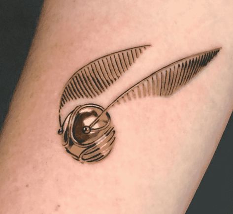 Harry Potter Golden Snitch Realistic Tattoo Tiny Harry Potter Tattoos, Golden Snitch Tattoo, Snitch Tattoo, Harry Potter Snitch, Harry Tattoos, Hp Tattoo, Harry Potter Golden Snitch, Harry Potter Tattoos, Harry Potter Tattoo