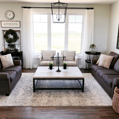 The farmhouse design is a style that focuses on the past and how our pre-technology farming generations decorated their homes.  Farmhouse decor i... | Hang a Statement Light as a Centerpiece Dark Couch, Modern Farmhouse Living, Dark Floors, Modern Farmhouse Living Room, Trendy Living Rooms, Country Living Room, Farmhouse Living, A Living Room, Small Living Room