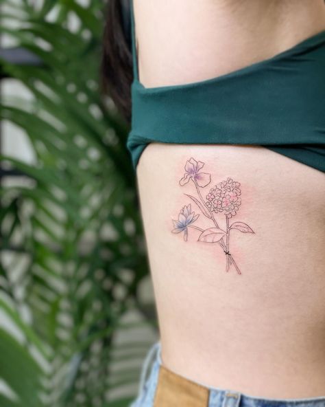 💐 freshly inked intentional, symbolic custom rib bouquet for A. Pink hydrangea also known for heartfelt emotion; purple iris reflecting wisdom, strength and courage; and then a blue lotus honoring the spirit beyond senses, peace from the kind of wisdom after suffering. Minimalist fine line work with some subtle color 🥰 looking forward to how this heals. Big love to @districtlocal for connections x community that made this possible!! This second win from our LNY Tattoo Giveaway was redeemed ... Tattoo Bouquet, Tattoo Giveaway, Hydrangea Tattoo, Bouquet Tattoo, Hydrangea Bouquet, Blue Lotus, Pink Hydrangea, Purple Iris, Line Work