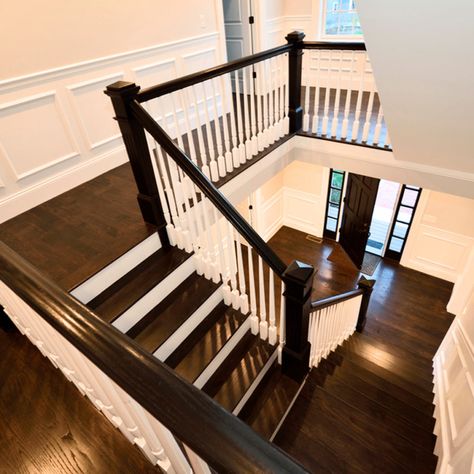 Dark wood flooring, white spinsters, and black rails. Feels like a timeless update. Wood Floor House, Stair Trim Ideas, Stair Landing Ideas, Staircase Color, Design For Stairs, Staircase Banister Ideas, Stairwell Design, American Colonial Decor, Stairs And Landing Ideas