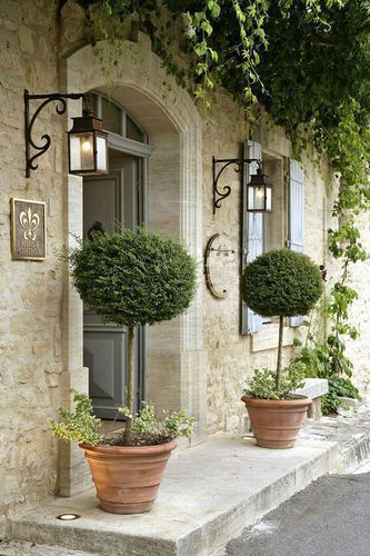 French Country Home | Topiaries, stonework and black scrolled iron on the light fixtures create a breathtaking entry that is still a little bit understated. French Farmhouse Decor, French Country Design, Have Inspiration, French Cottage, French Country Cottage, French Farmhouse, Country Design, French Country House, French Country Style