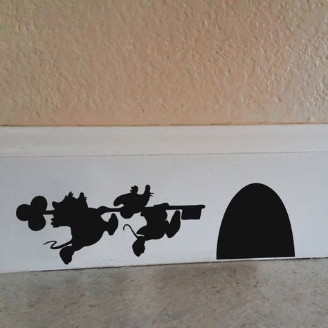 Check out these clever little illusion decals. These Disney Character Mouse Hole decals give the appearance of character shadows running to a mouse hole. These cute Disney Character Mouse Hole decals are made from a matte vinyl, to look like they’ve been painted on your walls. They easily come up, so there’s no mess or repainting necessary. … Minnie Mouse House, Casa Disney, Deco Disney, Cinderella Mice, Disney Bedrooms, Disney Room Decor, Mouse Hole, Disney Rooms, Disney Home Decor