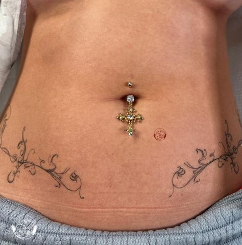 Flattering Stomach Tattoo, Spine Bone Tattoos For Women, Lower Pelvis Tattoo Women, Knee Border Tattoo, Hole Tattoo Band, Elegant Tramp Stamp, Hole Band Tattoo, Symetric Tattoo Stomach, Unique Lower Back Tattoos