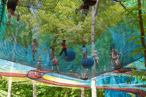 Bounce and Caper Among the Trees at UPLÅ, Canada's Biggest Trampoline Parks — Colossal Large Trampoline, Trampoline Parks, Concrete Exterior, Outdoor Trampoline, Wire Installation, Forest Canopy, Colossal Art, Creative Hub, Embrace Nature