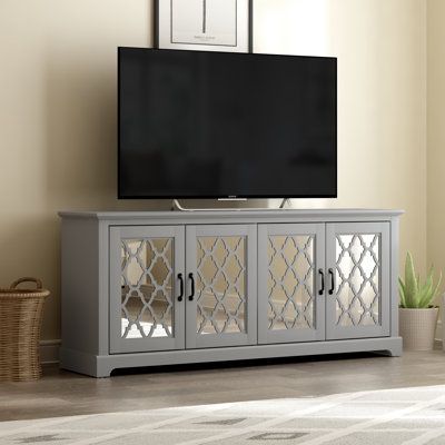 Anchor your living room or entertainment space with this charming TV stand. It crafted from manufactured wood, the mirror doors front design bring a luxe and accent style to this TV stand. You can pull the remove control, TV modem, or any stuffs into 2 spacious cabinets. Plus, it wide surface top offers enough rooms for your TV. This piece can also be used as a stately sidebourd in the your living room Color: Cool Gray | Rosalind Wheeler Abbie-May TV Stand for TVs up to 75 Wood in Gray | Wayfair Rustic Media Console, Wide Tv Stand, Trellis Panels, Television Stands, Farm House Colors, Living Room Tv Stand, Tv Stands And Entertainment Centers, Media Console, Grey Oak