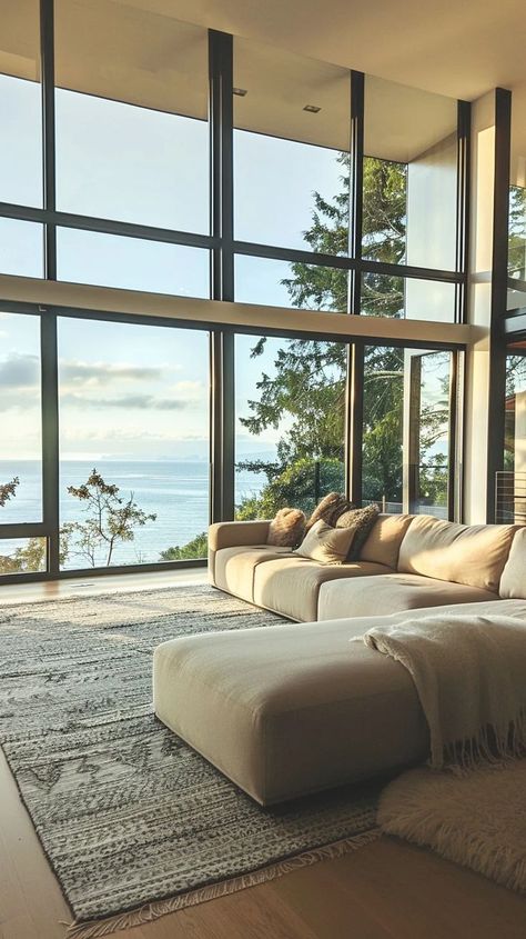 Modern living room with floor-to-ceiling windows, panoramic sea view, plush sofa, minimalist decor Connection With Nature, Plush Sofa, Floor To Ceiling Windows, Panoramic View, Sea View, Window Frame, The Minimalist, Modern Living Room, Modern Living