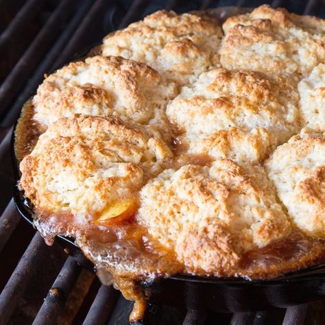 Up Your Glamping Game With Iron Skillet Campfire Peach Cobbler Campfire Peach Cobbler, Iron Skillet Peach Cobbler, Skillet Peach Cobbler, Camping Foods, Healthy Camping Food, Camping Dinners, Peach Desserts, Buttery Biscuits, Oven Canning