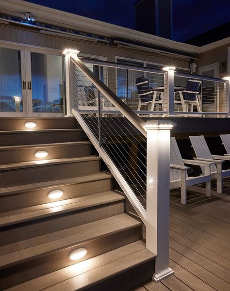 Add a soft, subtle glow to your deck with lighted island caps. Perfect for creating evening ambience. Easy on the Eyes Lights shine downward for a delicate radiance. A Subtle Glow Creates a slightly softer effect than a Post Cap Light. A Perfect Fit Fits beautifully with 5.5” post sleeves and post caps. Beautifully Integrated Designed to seamlessly coordinate with TimberTech Riser Lights, Under-Rail Lights, and Accent Lights. Low-Voltage Wiring 12 volts AC Raised Decks Backyard, Deck Post Solar Lights, Front Porch Post And Railing Ideas, Deck On Side Of House, Timbertech Railing, Back Steps To House, Front Step Railing Ideas, Under Deck Skirting Ideas, Timbertech Deck Ideas