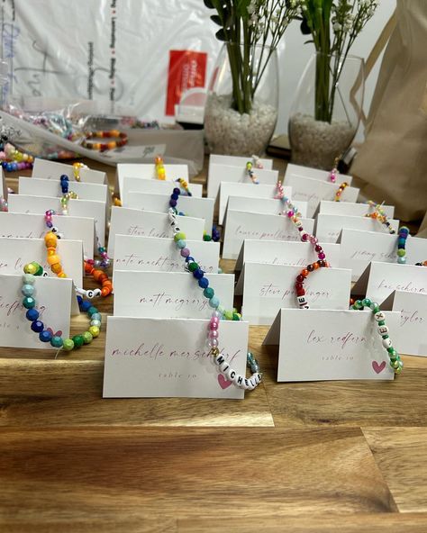 For my wedding of 120 guests, I made a friendship bracelet with each guest’s name and used bead colors unique to each person. We put each bracelet with the name card. I also made bracelets for the tables as decor, and put things like song lyrics, swiftie things, inside jokes, child names, or pet names at tables based on the seating chart. I did this as a Swiftie but was pleasantly surprised at how much all guests loved the bracelets- non-swifties included! I had so much fun making these brace... Bracelet Seating Chart, Wedding Guest Bracelet, Friendship Bracelet Seating Chart, Seating Name Cards Wedding, Wedding Friendship Bracelet, Swiftie Wedding, Child Names, Made Bracelets, Dinner Wedding