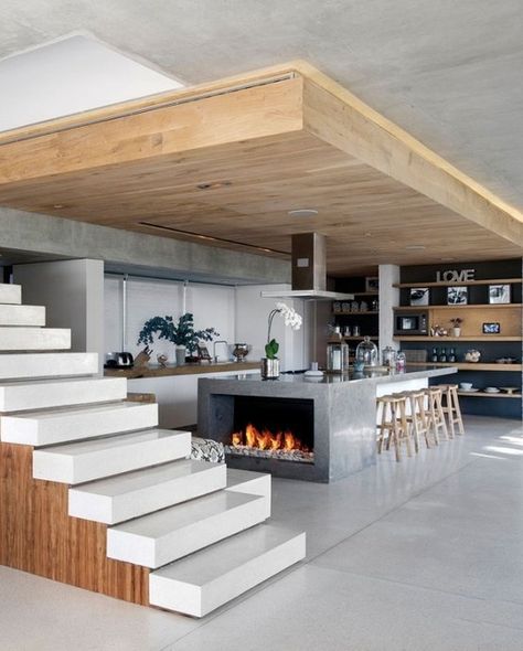 Modern kitchen island with fireplace, open stairs and XL overhang. Interesting design. Wood Benches, Modern Kitchen Island, Design Exterior, Industrial Loft, Design Del Prodotto, Hus Inspiration, Unique Kitchen, Hem Design, Ultra Modern