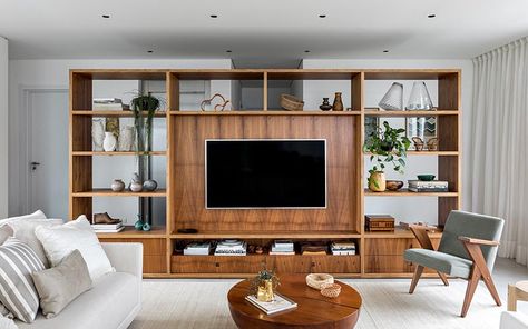 This modern room divider, made from Freijó wood, creates a space to welcome residents and visitors before reaching the open floor plan of the living room, kitchen, and dining area. From the living room side, the shelving unit provides a designated area for the TV in the living room, as well as storage in the form of bookshelves and drawers. #RoomDivider #WoodRoomDivider #WoodPartition #WoodShelving #LivingRoom #InteriorDesign #Interiors Wood Room Divider, Living Room Divider, White Headboard, Living Room Partition, Living Room Partition Design, Room Partition Designs, Room Partition, Dining Table Marble, Living Room Tv