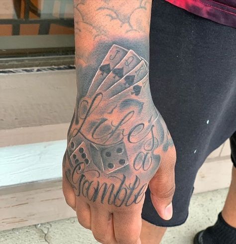 Life’s A Gamble Tattoo Design Hand, Life S A Gamble Tattoo, Life’s A Gamble Hand Tattoo, Lifes A Gamble Tattoos, Hand Tattoos For Black Men, Life Is A Gamble Tattoo, Trap Tattoos Men, Lifes A Gamble Tattoo, Gambling Tattoo Ideas