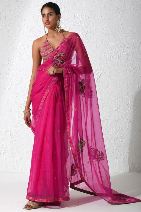 Featuring a hot pink saree in organza base with floral embroidery. It is paired with a matching raw silk bralette and a petticoat. . #perniaspopupshop #whatiwastrending #ppuslove #sareeset #saree #pinksaree #pink Halter Neck Saree, Hot Pink Saree, Pink Saree Blouse, Silk Bralette, Embroidered Saree, Saree Border, Ethnic Outfits, Indian Designer Outfits, Saree Look