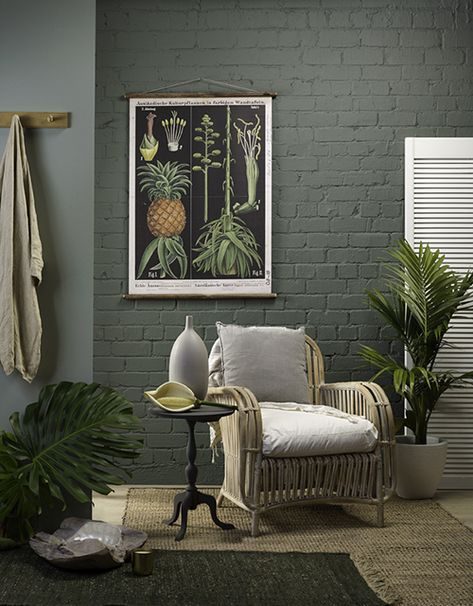 Resene Easy Rider on the brick wall is teamed up with paler Resene Inside Back. Add a botanical print, a jute rug, wicker chair with linen cushions and a potted palm – it’s simple and fresh without being stark. The classic tri-leg side table is painted in Resene Wireless, the urn on top is in Resene Triple Rakaia, and the shutter and the plant pot are in Resene Triple Merino. Painted Brick Interior Wall, Painted Brick Wall Interior, Interior Brick Wall Ideas, Painted Brick Interior, Brick Wall Ideas, Brick Wall Living Room, Painted Brick Wall, Brick Wall Backdrop, Painted Brick Walls