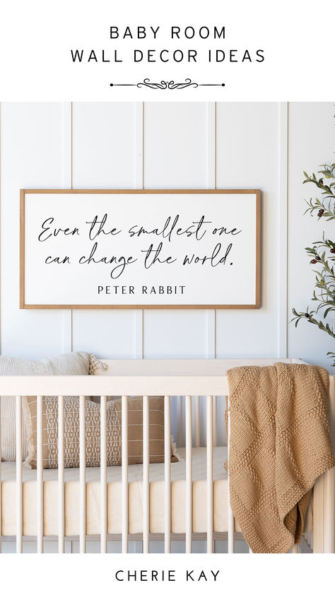 A cozy nursery with a wooden crib adorned with neutral-toned bedding and a knitted blanket draped over the edge. Above the crib hangs a framed sign with the quote "Even the smallest one can change the world." by Peter Rabbit. The room has a serene and minimalist design, perfect for a baby’s room. Nursery Signs Quotes, Toddle Room, Decor Above Crib, Nursery Wall Quotes, Batten Board, Panda Nursery, Peter Rabbit Nursery, Baby Room Wall Decor, Nursery Quotes