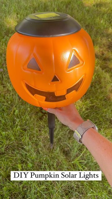 Pumpkins On Fence Posts, Plastic Pumpkin Over Solar Lights, Lighted Pumpkins On Porch, Pumpkins With Lights, Pumpkin Lights Outside, Pumpkin Bucket Solar Lights, Halloween Pumpkin Bucket Ideas, Diy Pumpkin Bucket Decor, Plastic Pumkin Decoration Ideas Easy