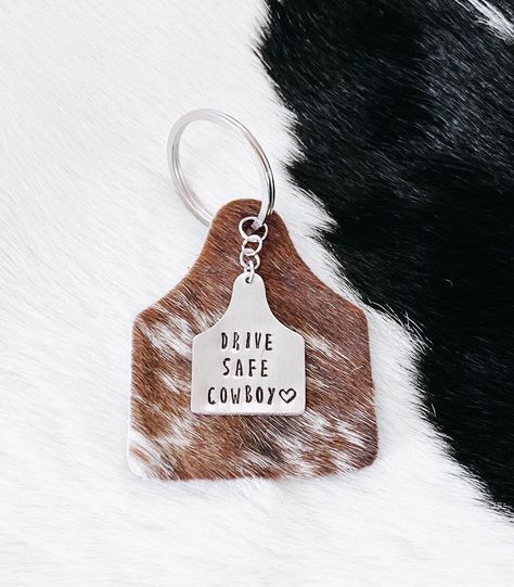 "3\" x 2.5\" authentic Brazilian cowhide keychain with a 1\" keyring & leather backing⚡️ Hide colors vary! Please specify if you have any preferences. These are hand-stamped and packaged by me. Due to each keychain being hand-stamped, the spacing and color may vary slightly from pictures. If you have any questions please feel free to reach out! \"Drive Safe Cowboy\" keychain without cowhide: https://etsy.me/3cl4gpj" Cowboy Gifts For Men Westerns, Cute Western Gifts, Western Key Chain, Drive Safe Cowboy Keychain, Boyfriend Gifts Country, Gifts For Your Country Boyfriend, Cowboy Boyfriend Gifts, Cute Western Car Accessories, Western Gifts For Boyfriend