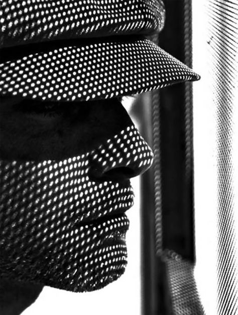 The lines and dots through the man's face and hat makes the texture of whatever is casting the shadow stand out as well as giving the subject a comic book character look. Black And White Spider, Shadow Silhouette, Shadow Photography, White Pictures, Black And White Photograph, Shadow Art, Foto Tips, Shadow Play, Photography Subjects