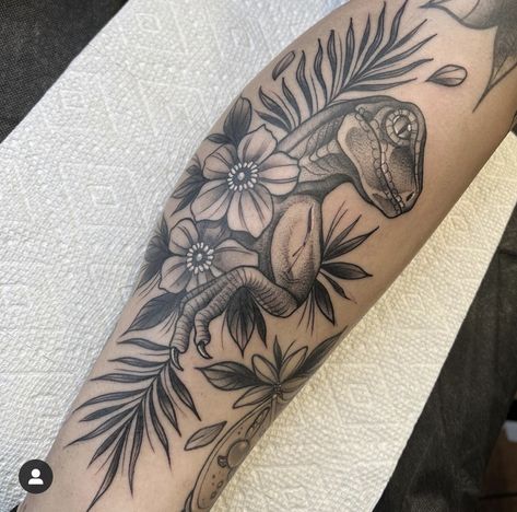 Dinosaur Tattoo For Daughter, Prehistoric Tattoo Sleeve, Tattoo Ideas Female Dinosaur, Womens Dinosaur Tattoo, Dinosaur Tattoos For Women, Floral Dinosaur Tattoo, Dinosaur Skull Flower Tattoo, Jurassic Park Tattoo, Dinosaur Tattoos