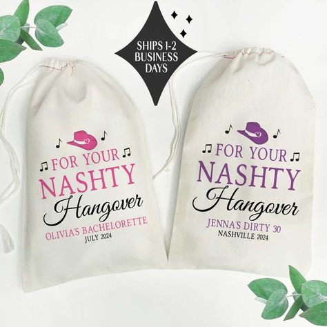 "These fun Nashville hangover kit bags come with the cowboy hat \"For your Nashty Hangover\" design as shown, in your choice of 3 sizes of reusable canvas gift bags. Choose the design accent color and add 1-2 lines of custom text to personalize your bags.  𝗣𝗘𝗥𝗦𝗢𝗡𝗔𝗟𝗜𝗭𝗘 𝗬𝗢𝗨𝗥 𝝗𝗔𝗚𝗦 * Add your custom text, 1-2 lines  (using up to 30 characters MAXIMUM per line) Enter text in this format: Line 1: Line 2: * Character limit includes spaces & punctuation * Text will be printed in lettering colors and style shown: 𝗔𝗟𝗟 𝗖𝗔𝗣𝗦  *No symbols, accented letters or non-standard characters. 𝙋𝙇𝙀𝘼𝙎𝙀 𝙉𝙊𝙏𝙀: Text that is not entered in the correct format or that exceeds the character limit may result in your order being delayed or rejected. 𝗖𝗛𝗘𝗖𝗞 𝗧𝗛𝗘𝗦𝗘 𝗢𝗨𝗧 🤠 * Shop Birthday Recovery Kit, Nashville Birthday, Bachelorette Hangover Kit, Save Water Drink Champagne, Hangover Kit Bags, Canvas Gift Bag, Hangover Kit, Nashville Bachelorette, Nashville Trip