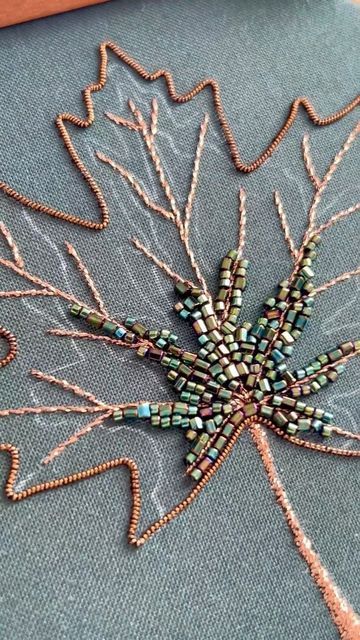 Kate • Hand Embroidery Artist on Instagram: "A short video of what I’ve finished so far on my current work in progress, a beaded maple leaf. 🍁 

I started out stitching an outline with some goldwork wire that isn’t actually gold, lol. In fact it’s a really pretty bronze-brown. Then I used a metallic embroidery thread to fill in the leaf stem and veins. Finally it’s on to the beading, which is what we’re all here for!

As you can already tell, this maple leaf isn’t going to be the typical fiery orange in the height of Fall foliage. I actually decided to go a more transitional color palette, so the beads closest to the leaf center are still a deep green. You’ll just have to stick around to see how the rest of the beading turns out! ☺️✨

#goldworkembroidery #beadembroidery #embroideryartist Transitional Color Palette, Embroidery Pins, Gold Work Embroidery, Embroidery Leaf, Metallic Embroidery, Work Art, Patch Work, Gold Work, Bead Embroidery