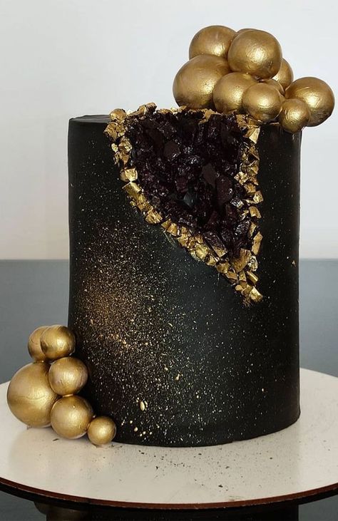 15. Black and Gold Geode Cake We love to eat cakes. No matter whatever their age, a birthday celebration isn’t complete without a cake.... Gold Black Cake, Cake Ideas Black And Gold, Black Birthday Themes For Women, Birthday Cakes Black, Black Cakes Birthday For Women, Black Cake Design, Black Theme Cake, Chocolate Geode Cake, Black And Golden Cake Birthday