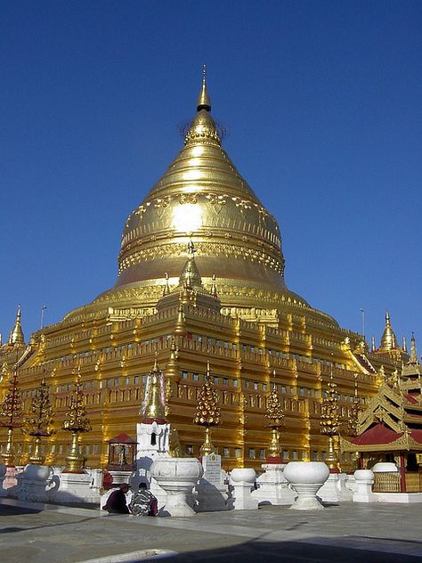 The Shwezigon Pagoda or Shwezigon Paya (Burmese: ရွှေစည်းခုံဘုရား) is a Buddhist temple located in Nyaung-U, a town near Bagan, in Burma (Myanmar). It is a prototype of Burmese stupas, and consists of a circular gold leaf-gilded stupa surrounded by smaller temples and shrines. Construction of the Shwezigon Pagoda began during the reign of King Anawrahta and was completed in 1102 AD, during the reign of King Kyansittha of the Pagan Dynasty Shwezigon Pagoda, Bagan Temples, Naypyidaw, Pagoda Temple, Bagan Myanmar, Myanmar Art, Buddhist Temples, Burma Myanmar, Temple Architecture