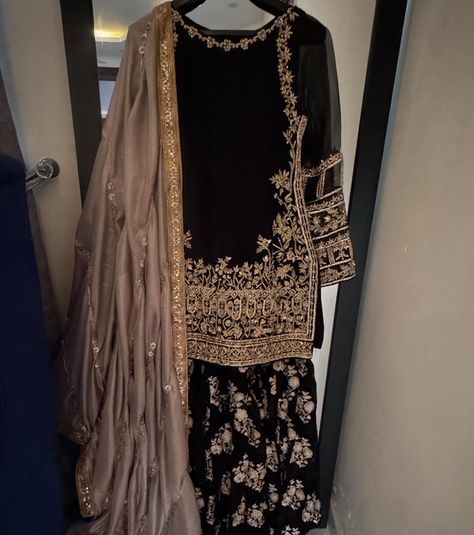 It’s all about black, a perfect wedding outfit for this upcoming wedding season Black formal outfit with zardozi work on shirt paired with embellished gharara and gotta finished silk dupatta For order and details please dm | visit kehkeshan.aamir | or whatsapp us on 03115693004 [ Kehkeshan kehkeshanz black gharara formal wedding wear laamofficial Pakistanifashion ] Black And Gold Gharara, Gold Gharara, Black Formal Outfit, Black Gharara, Cotton Sharara, Desi Outfits, Zardozi Work, Pakistani Fashion Casual, Punjabi Dress