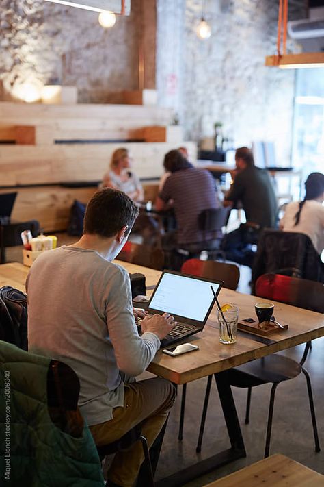 Stock photo of Young businessman working with computer and phone in a cafeteria by EstudiM6 Work Men Aesthetic, Work In Coffee Shop, Work Space Cafe, Work From Coffee Shop, Cafe With People, Work In Cafe, Coffee Shop Laptop, Man On Computer, Work Cafeteria