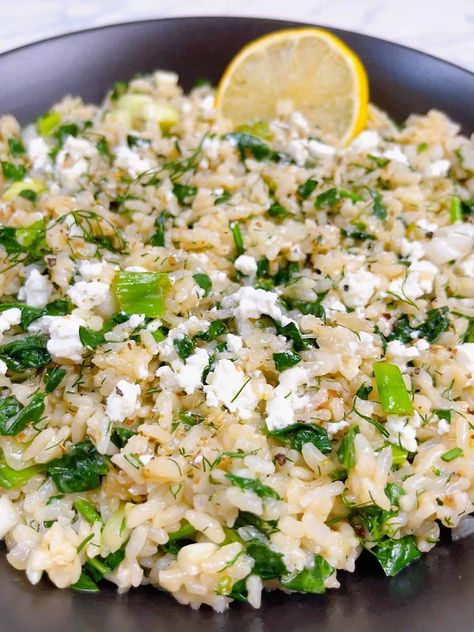 spanakorizo greek spinach rice with lemon and dill in the instant pot hero image close up in black bowl with lemon and feta crumbled. Greek Hummus Recipe, Greek Lentil Soup Recipe, Authentic Tzatziki Sauce Recipe, Rice With Lemon, Greek Lentil Soup, Greek Stuffed Peppers, Greek Rice, Greek Spinach, Avgolemono Soup