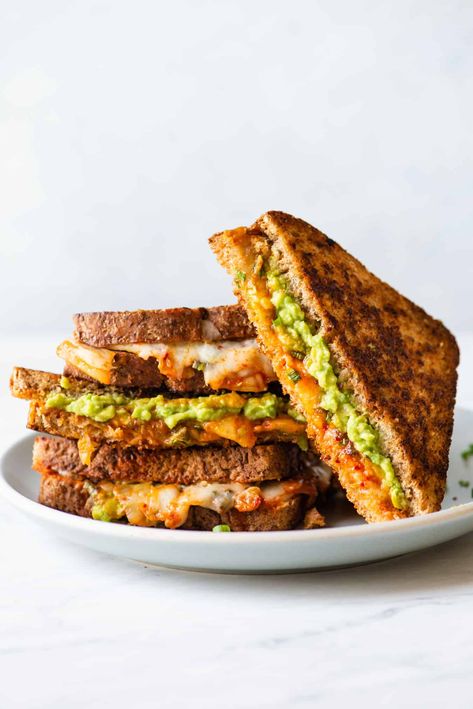 This kimchi and avocado grilled cheese sandwich is a quick and delicious weeknight meal. The richness of the cheddar cheese and mashed avocado balances nicely with the tangy and spicy flavors of kimchi. This is a quick meal that’s ready in 15 minutes! Avocado Grilled Cheese, Resep Sandwich, Vegetarian Grilling, Monte Cristo Sandwich, Grill Cheese Sandwich Recipes, Cheese Sandwich Recipes, Quick Vegetarian Meals, Grilled Cheese Recipes, Healthy Sandwiches