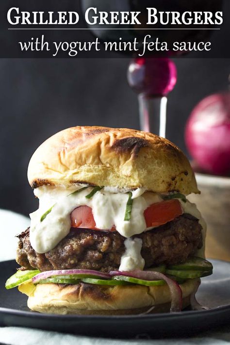 These grilled Greek burgers are made from ground beef and spices then paired with a Mediterranean yogurt mint feta sauce and a cucumber onion salad. Juicy and packed full of flavor! | justalittlebitofbacon.com #summerrecipes #grillrecipes #burgerrecipes #burgers #mediterraneandiet #grilling #groundbeef Gourmet Cheeseburgers, Mediterranean Yogurt, Greek Burgers, Lamb Meatballs Greek, Feta Sauce, Cucumber Onion Salad, Greek Burger, Cucumber Onion, Fresh Bread Crumbs