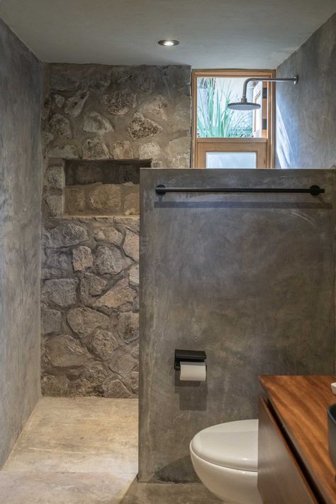 This Modern House Was Made From Locally Sourced Stone Outside Bathroom Ideas Backyards, Outside Bathroom Ideas, Wood And Concrete Interior, Concrete Bathroom Design, Partial Wall, Entertainment House, Minimal Bathroom Design, Industrial Bathroom Design, Minimal Bathroom