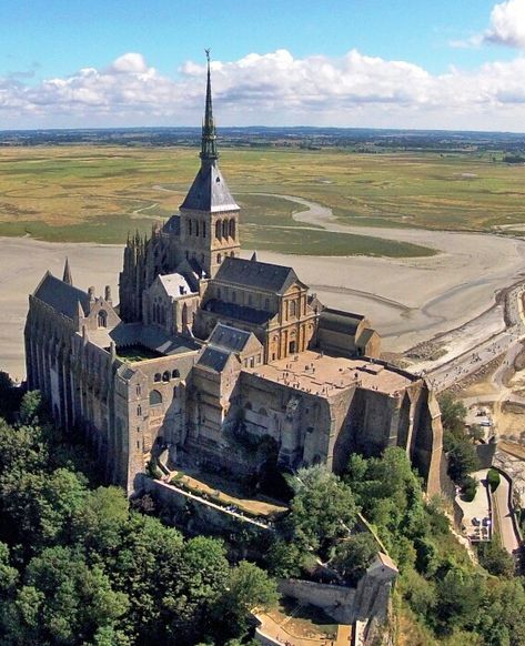 The abbey church that towers over the island has an imposing 11th-and 12th-c. Romanesque nave and an elegant choir in Flamboyant Gothic style (built 1450-1521). The tower and spire, crowned by a statue of St.Michael, were added in the 19th cent. The church is built over three crypts,the oldest dating probably from Carolingian times (8th-10th century). Flamboyant Gothic, Mt St Michel, Mont Saint Michel France, France Landscape, Medieval Fair, Mont St Michel, Religious Architecture, Cathedral Church, Normandy France