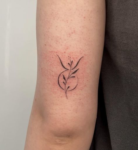 Taurus zodiac symbol tattoo on the outer arm Dainty Taurus Tattoo For Women, Taurus Small Tattoo For Women, Taurus Wildflower Tattoo, Taurus Birth Flower Tattoo, Taurus Symbol Tattoo Design, Daisy Taurus Tattoo, May Taurus Tattoo, Taurus Sun Tattoo, Simple Taurus Tattoo For Women