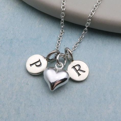 These necklaces make ideal valentines gifts. Two sterling silver initials with a cute little heart charm in between on a delicate sterling silver chain. Each one comes nicely packaged in one of our branded jewellery gift boxes. • Sterling silver • Silver heart - W11mm x H9mm Discover our range of Pr Logo, Sterling Silver Charm Necklace, Silver Charm Necklace, Couple Necklace, Alphabet Images, Initial Tattoo, Indian Sculpture, Gifts For Girlfriend, Picture Letters