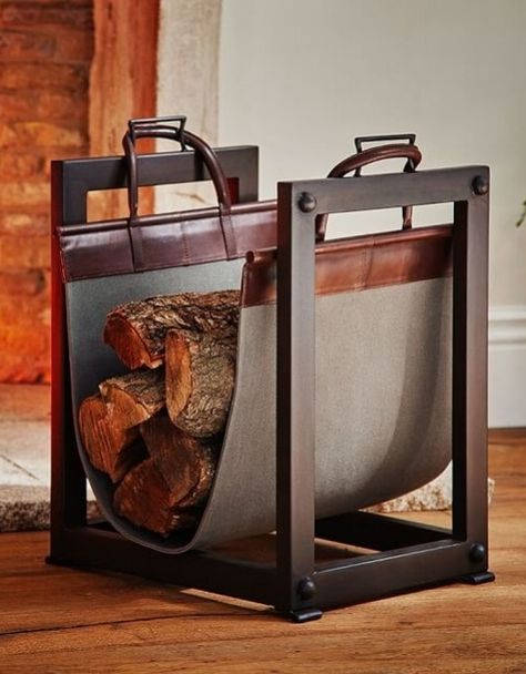 A sturdy iron frame and canvas-and-leather sling on Pottery Barn';s Industrial log carrier/holder make it both handsome and functional | archdigest.com Industrial Fireplaces, Industrial Fireplace, Indoor Firewood Rack, Firewood Storage Indoor, Log Carrier, Classic Fireplace, Firewood Holder, Industrial Inspiration, Fireplace Logs