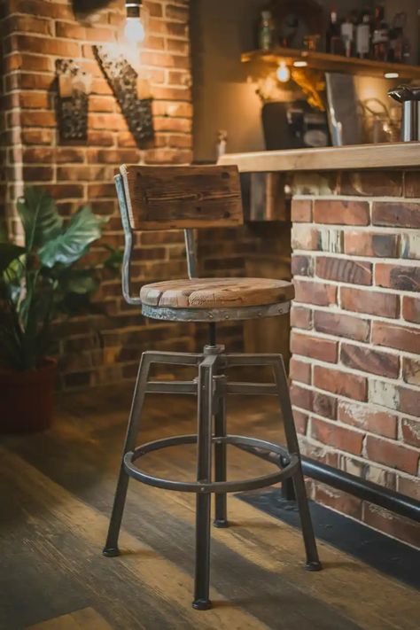 Rustic wooden bar stool with metal frame in a cozy brick-walled bar setting. Industrial Bar Stools With Back, Fabric Bar Stools, Fabric Bar, Fabric Bar Stool, Bar Stool Seats, Industrial Bar Stools, Stools For Kitchen Island, Bar Stools With Backs, Industrial Bar