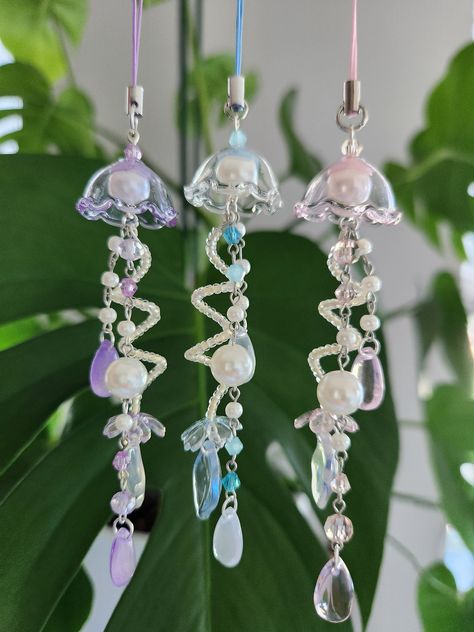 beautiful handmade pearl jellyfish phone charm in a cute coquette style also available as a keychain Pearl Phone Charm, Kawaii Coquette, Keychain Pink, Diy Jewelry Earrings, Mermaid Aesthetic, Beaded Jewlery, Diy Bracelet Designs, Cute Keychain, Beaded Bracelets Diy