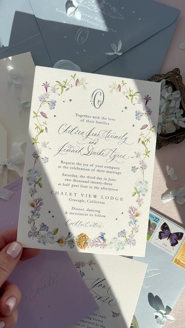 Nicole | Invitation Designer on Instagram: "Holographic moons and stars with blue foil on the invitation- this suite has the dreamiest color palette < 🌈 > . . . . #holographic #custominvitation #foil #floral #calligraphy #vintagepostage #wedding #weddinginspiration #2023bride #bridetobe #rainbow #weddinginvitation #waxseal #fyp #design #color" Garden Party Wedding Palette, Wedding Invitations Korean, Garden Wedding Stationary, Garden Party Color Palette, Cottagecore Invitation, Bridgerton Invitation, Wedding Invitation Cards Elegant, Whimsical Wedding Stationery, Broadmoor Wedding