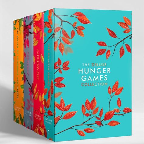 The new Deluxe Hunger Games 4 book Collection Hardcover box set featuring new cover art for The Hunger Games, Catching Fire, Mockingjay, and The Ballad of Songbirds and Snakes. The art features different solid color backgrounds for each book, with new black mockingjay art for each book and different colored leaves. The mockingjays are in the style of the original novels but black instead of gold. The Hunger Games is aqua blue, Catching Fire is red, Mockingjay is lavender, Ballad is gold. Hunger Games Book Cover, Hunger Games Book, New Hunger Games, The Hunger Games Books, Hunger Games Books, Hunger Games Series, Hunger Games Catching Fire, Hunger Games Trilogy, Suzanne Collins