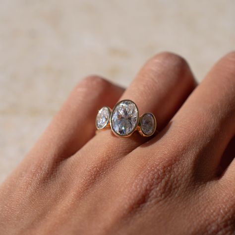 This alternative style three stone oval engagement ring features a full bezel setting for each stone, lifted onto the finger for a grand finish. Sublime 🤍 Details: - 2ct oval moissanite centre - 2x 0.4ct oval moissanite accent stones - 18k yellow gold - 2mm wide shank #engagementringdesign #customengagementring #bespokeengagementring #threestoneengagementring #moissaniteengagementring #nz #aus Three Stone Bezel Set Ring, Three Stone Oval Engagement Ring, Oval Engagement Ring, Bezel Engagement Ring, Bespoke Engagement Ring, Bezel Set Ring, Alternative Style, Oval Engagement, Oval Moissanite