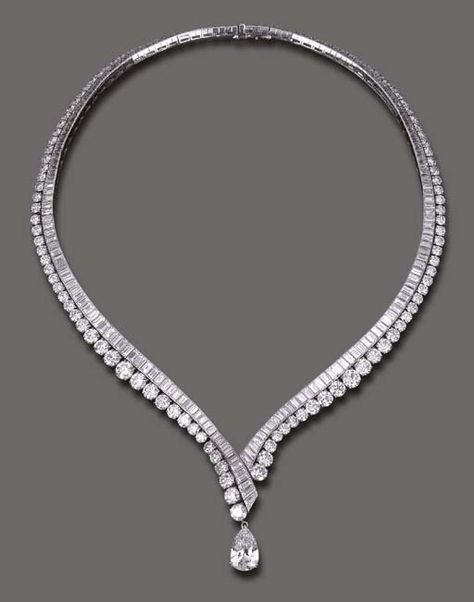 AN ELEGANT DIAMOND NECKLACE, BY VAN CLEEF & ARPELS  The flexible V-shaped baguette-cut diamond line, enhanced by graduated circular-cut diamond trim, the front suspending a detachable pear-shaped diamond, weighing approximately 4.11 carats, mounted in platinum and 18k gold, 16 ins., with French assay marks and maker's mark, in a Van Cleef & Arpels blue suede envelope case Van Cleef Arpels Blue, Elegant Diamond Necklace, Diamond Necklace Simple, Diamond Necklace Designs, Simple Diamonds, Diamond Jewelry Necklace, Solitaire Pendant Necklace, Van Cleef Arpels, Van Cleef