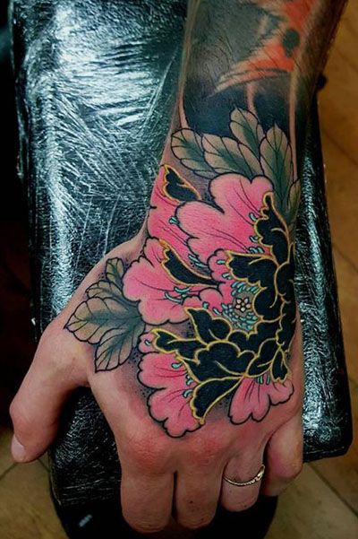 25 Cool Hand Tattoos For Those Who Love Ink - The Trend Spotter Japanese Flower Hand Tattoo, Colorful Hand Tattoos For Women, Hand Tattoo Color, Japanese Hand Tattoo, Peony Hand Tattoo, Baku Tattoo, Best Hand Tattoos, Hand Tattoo Design, Swag Tattoo