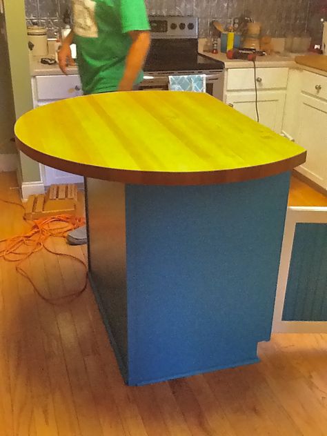 The awesome new island top that we bought from Habitat for Humanity. It was an old 100% wood table. Dave sawed off one end to make it a semi-circle (over the drawers and cupboards) and we sanded it and re-stained it. It's much less yellow than it looks here. A $20 DIY! Semi Circle Table, Caravan Ideas, Habitat Restore, Circle Table, Dry Bar, Habitat For Humanity, Summer Kitchen, Bar Top, Kitchen Islands