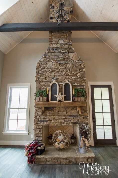 2 story fireplace in vaulted ceiling with stacked stone and hand-hewn mantel Farmhouse Sink Faucet, Vaulted Ceiling Living Room, Brick Fireplace Makeover, Living Room Themes, Farmhouse Fireplace, Rustic Fireplaces, Building Company, Faux Fireplace, Chic Farmhouse