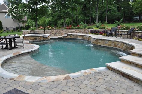 Freeform Pool/Spa with Stone Retaining Wall Retaining Wall Pool, Pool Retaining Wall, Backyard Retaining Walls, Pool Diy, Freeform Pools, Pool Outfits, Stone Retaining Wall, Pool Remodel, Pools Backyard