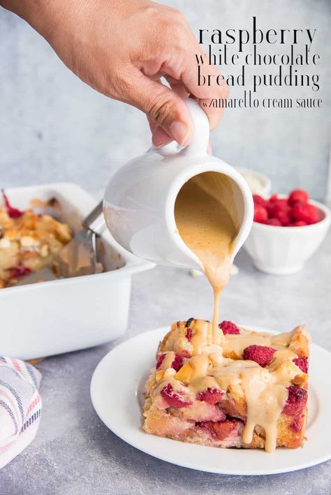 Raspberry White Chocolate Bread Pudding with Amaretto Cream Sauce is a decadent, fruity dessert that is simple to assemble and can bake while you prepare tonight's dinner. Bonus: it also tastes amazing as a breakfast or brunch dish. #raspberrybreadpudding #whitechocolatebreadpudding #breadpudding #breadpuddingrecipe #baking #dayoldbreadrecipe #challah #pansobao #frenchbread #bakingrecipes #whitechocolaterecipes #summerdessert #dessert #brunch #breakfast #breadpuddingdessert #amarettosauce via @e Raspberry White Chocolate Bread Pudding, Raspberry Bread Pudding Recipe, Amaretto Sauce, Raspberry Bread Pudding, Almond Custard, Jello Deserts, White Chocolate Bread, Bread Pudding Dessert, Amaretto Cream